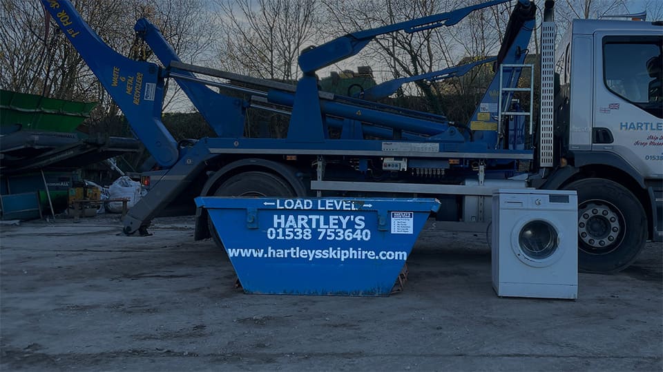two tonne mini skip next to washing machine to compare skip size